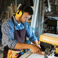 Crafting with Care: Understanding the Risks to Your Eyes Man woodworking while wearing safety goggles