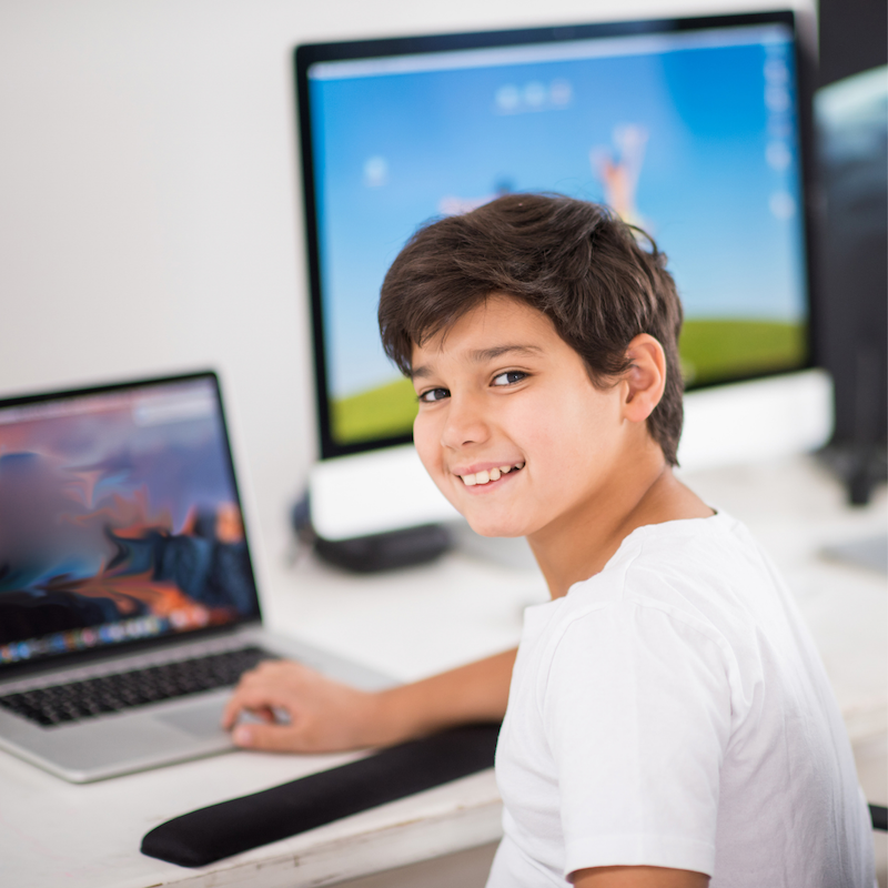 Image of a child in front of a laptop.